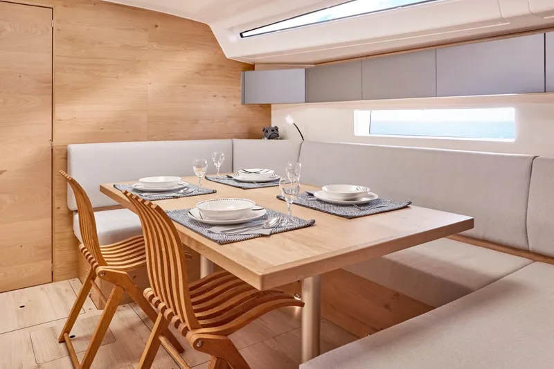 Slide: The Image of Modern dining area inside 2024 Elan Impression 43 yacht with wooden table and chairs. - 12