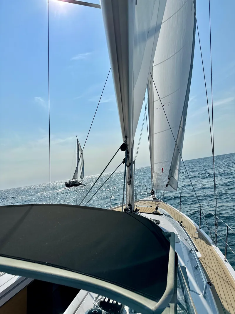 Slide: The Image of 2024 Elan Impression 43 sailing on open sea under clear blue sky. - 16