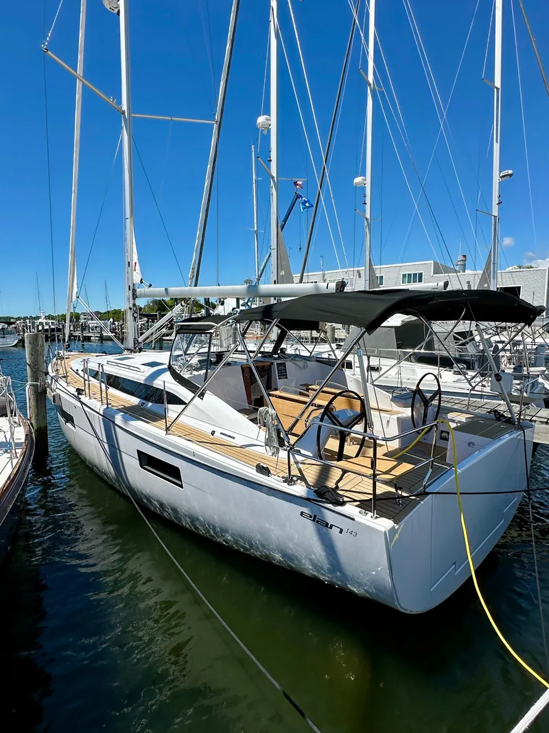 Slide: The Image of 2024 Elan Impression 43 sailboat docked in marina under clear blue sky. - 17