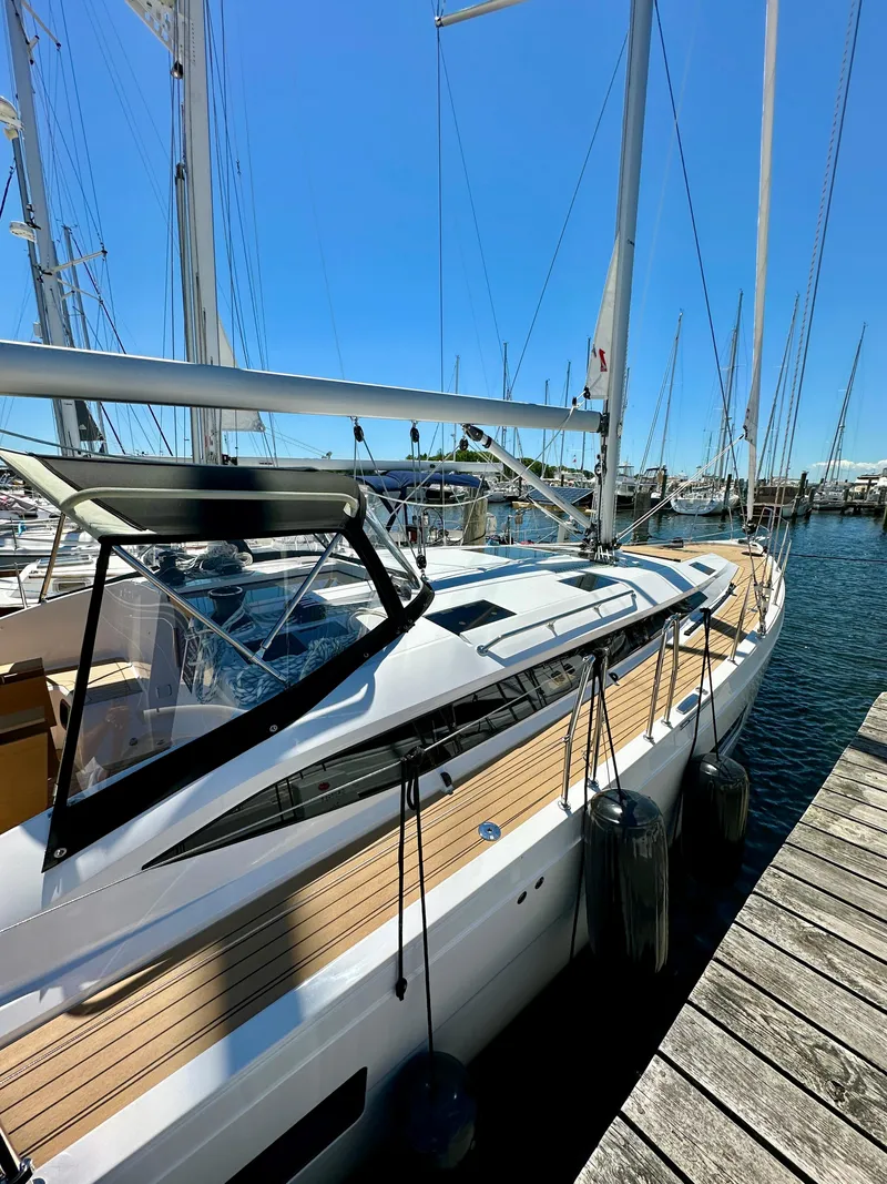 Slide: The Image of 2024 Elan Impression 43 yacht docked at marina under clear blue sky. - 18
