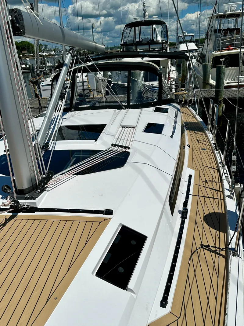 Slide: The Image of 2024 Elan Impression 43 sailboat docked, showcasing sleek deck design and modern features. - 21