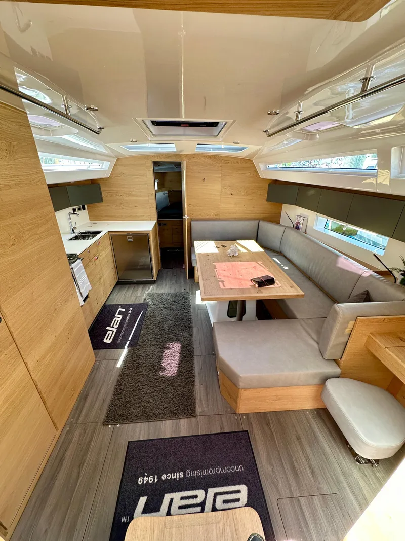 Slide: The Image of 2024 Elan Impression 43 yacht interior with modern kitchen and cozy seating area. - 29