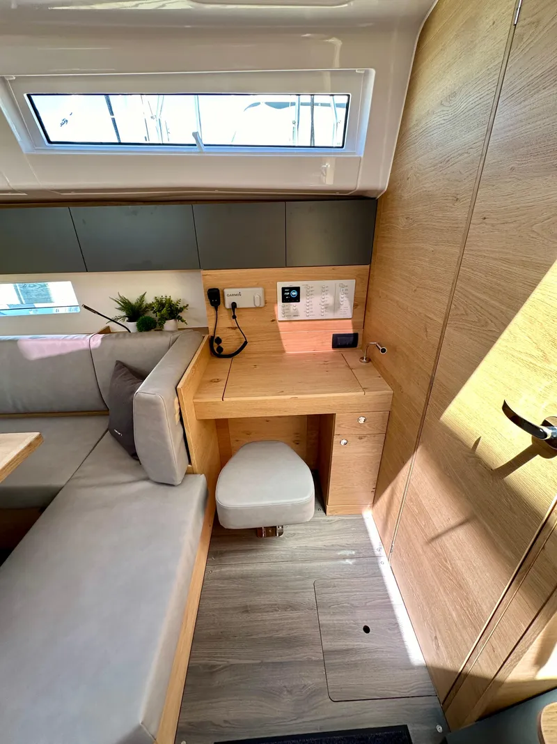 Slide: The Image of 2024 Elan Impression 43 yacht interior with modern seating and workspace. - 31