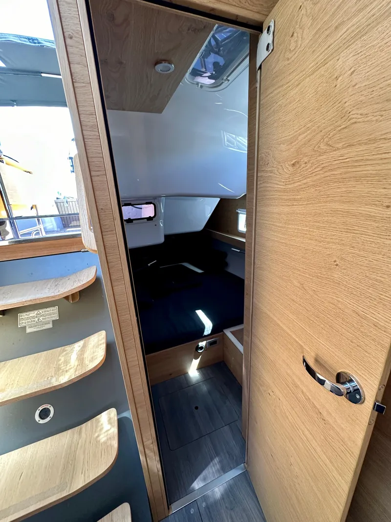 Slide: The Image of Interior of 2024 Elan Impression 43 yacht, featuring modern wood finishes and cozy cabin space. - 35
