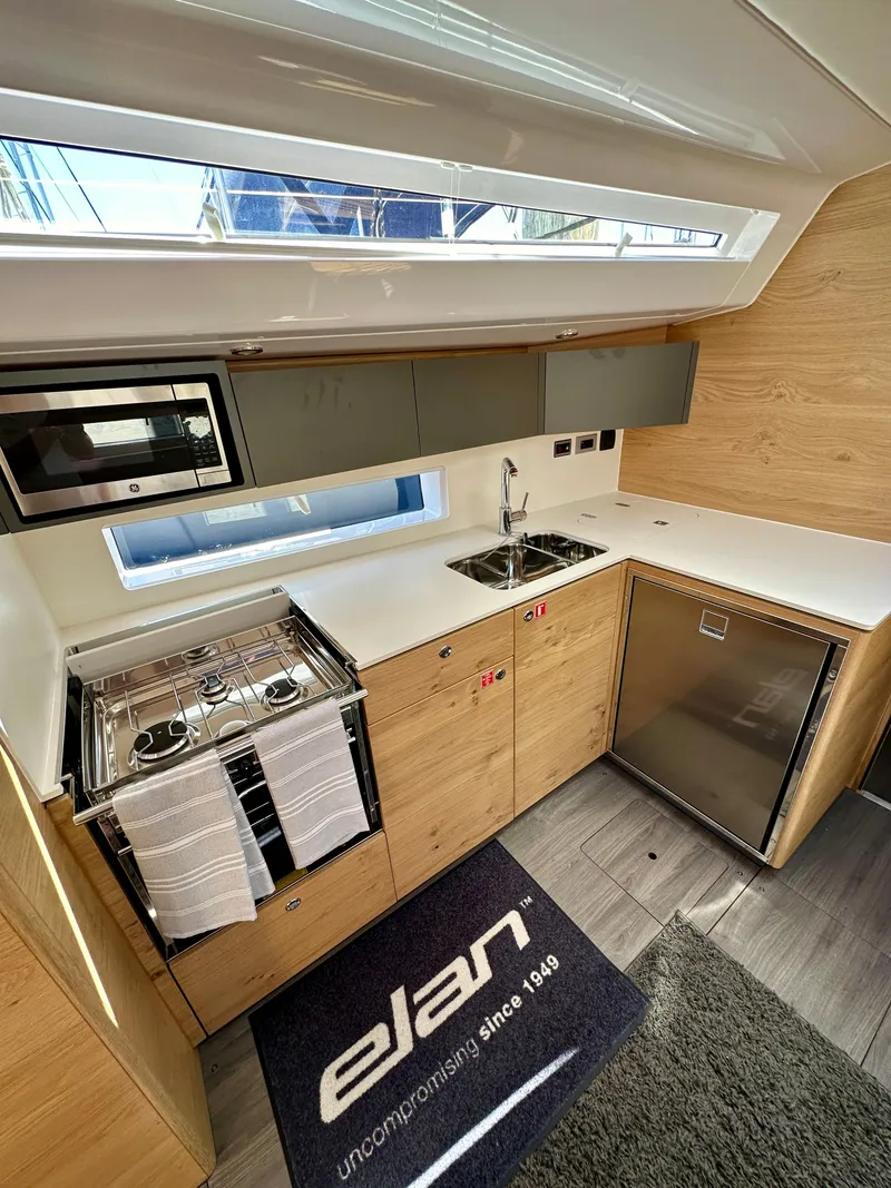 Slide: The Image of Modern kitchen in 2024 Elan Impression 43 yacht with sleek appliances and wood finish. - 38