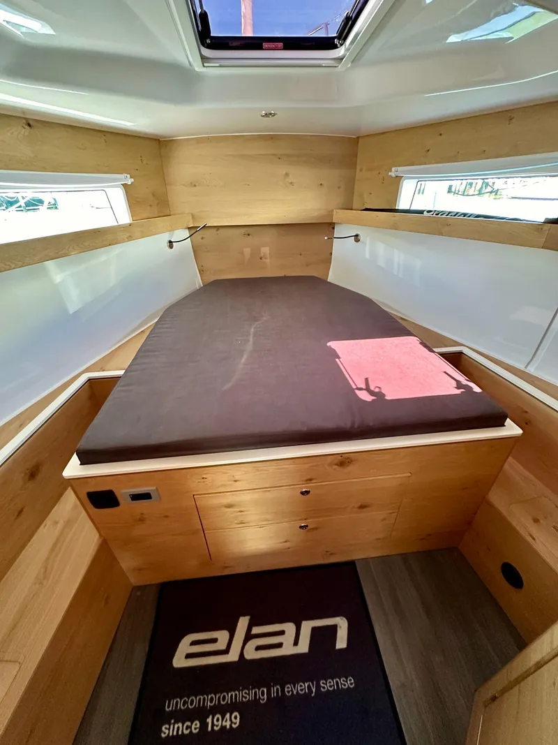 Slide: The Image of 2024 Elan Impression 43 cabin interior with wooden finish and skylight. - 39