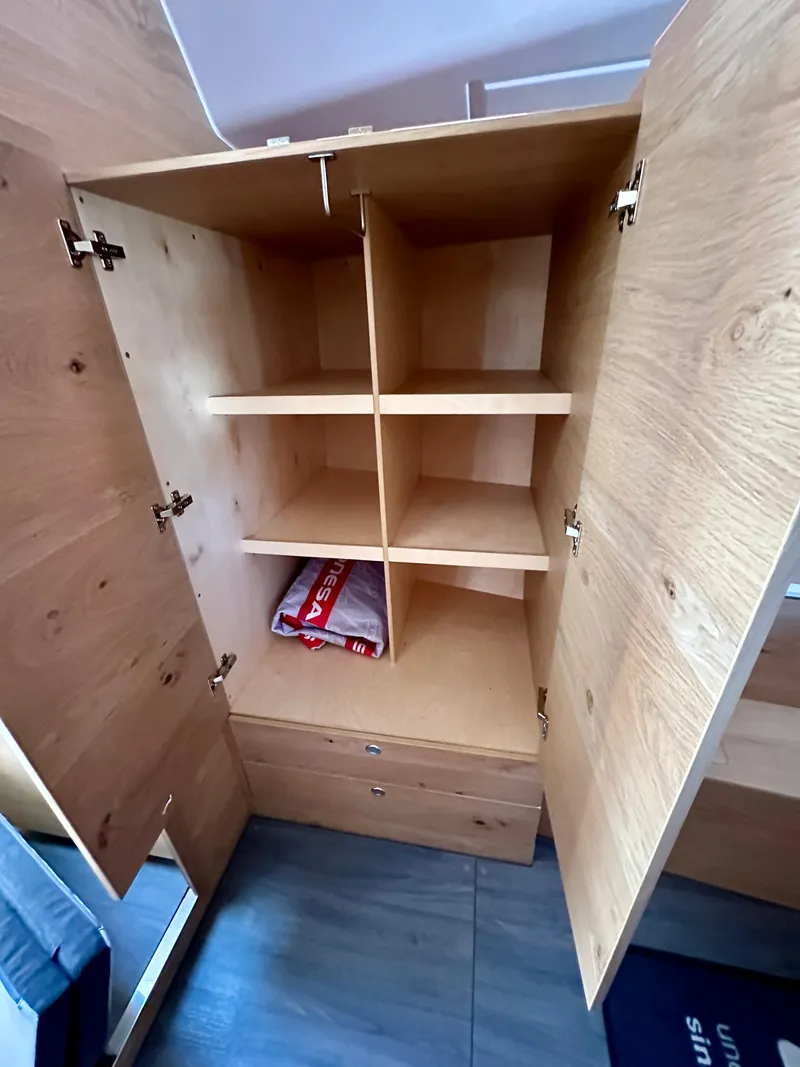 Slide: The Image of Open wooden cabinet with shelves and drawers in Elan Impression 43, 2024 model. - 42
