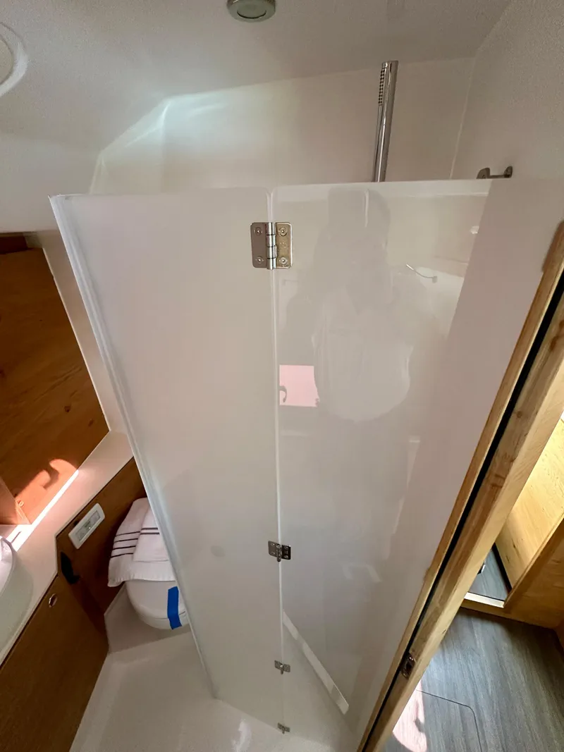 Slide: The Image of 2024 Elan Impression 43 yacht bathroom with modern shower and wooden accents. - 43