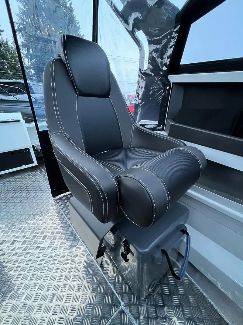 Slide: The Image of Captain's seat in 2024 Stabicraft 1850 Fisher boat, featuring black upholstery and diamond plate flooring. - 10