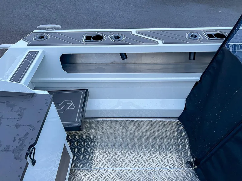 Slide: The Image of Interior of 2024 Stabicraft 1850 Fisher boat with storage compartments and non-slip flooring. - 15