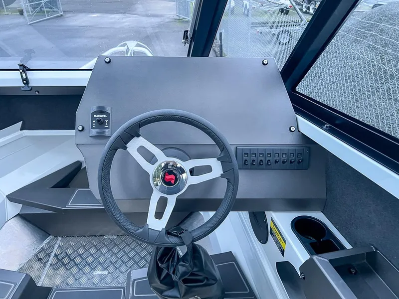 Slide: The Image of 2024 Stabicraft 1850 Fisher boat dashboard with steering wheel and control panel. - 7