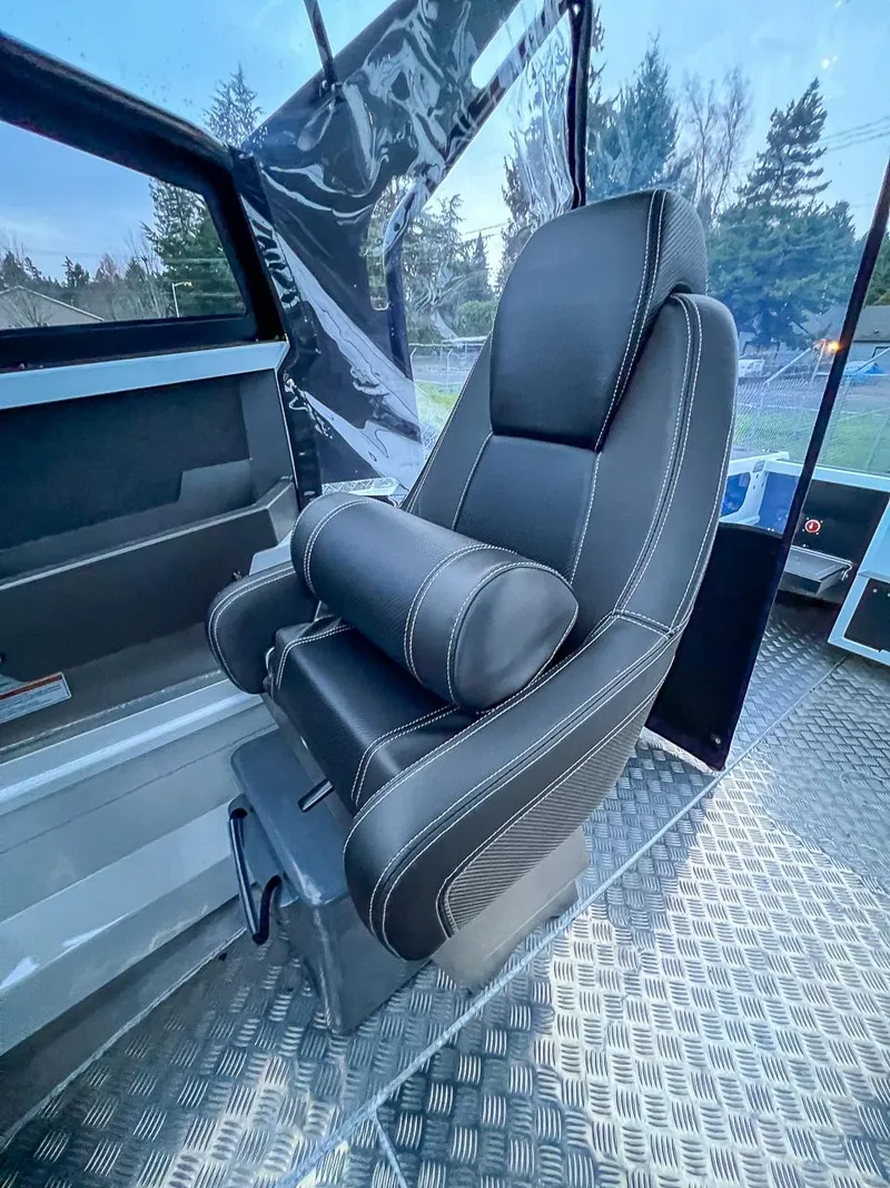 Slide: The Image of 2024 Stabicraft 1850 Fisher interior seat with black upholstery and white stitching. - 9