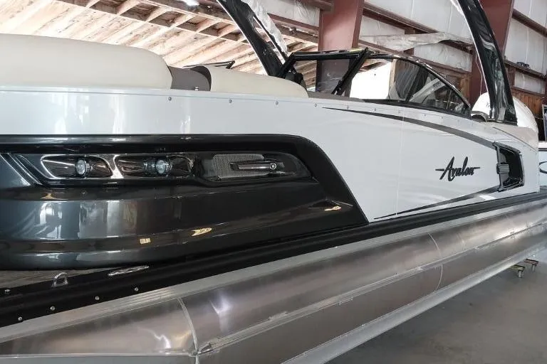The Image of 2023 Avalon Excalibur Quad Lounge Windshield pontoon boat, sleek design, outdoor setting. - 0