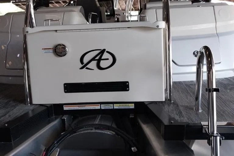 Slide: The Image of 2023 Avalon Excalibur Quad Lounge Windshield boat with spacious seating, parked near a road. - 12