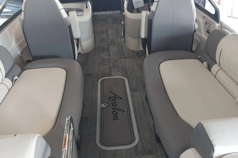 Slide: The Image of 2023 Avalon Excalibur Quad Lounge Windshield boat interior with luxurious seating and modern design. - 13