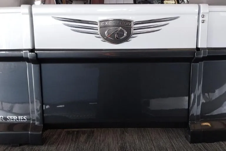 Slide: The Image of 2023 Avalon Excalibur Quad Lounge Windshield boat, Saltwater Series, parked outdoors. - 2