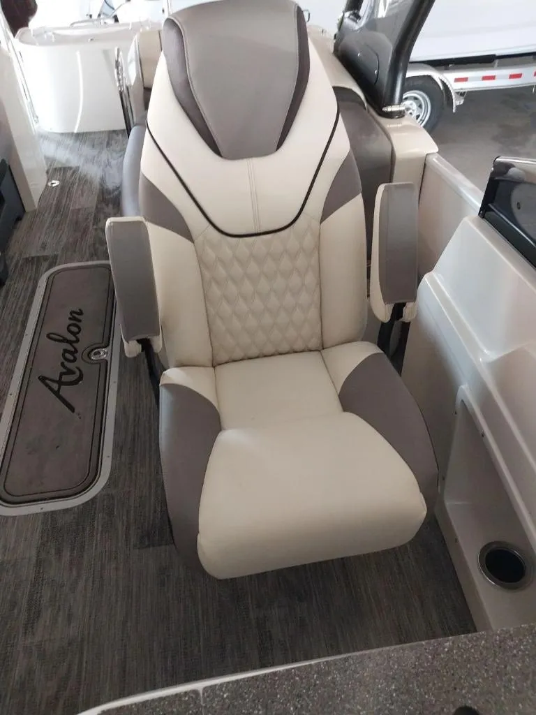 Slide: The Image of 2023 Avalon Excalibur Quad Lounge Windshield boat seat with luxurious design. - 21