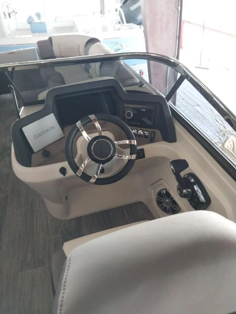 Slide: The Image of 2023 Avalon Excalibur Quad Lounge Windshield boat with Mercury outboard motor, docked outdoors. - 3