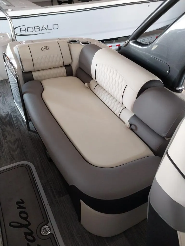 Slide: The Image of 2023 Avalon Excalibur Quad Lounge Windshield boat with spacious seating and modern design. - 7