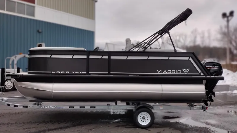 The Image of 2024 Viaggio Lago X18U pontoon boat on trailer, side view, outdoors. - 0
