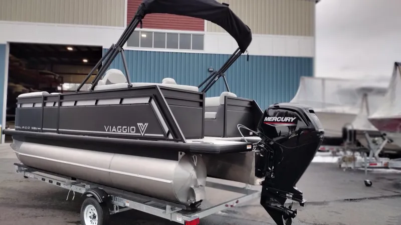 Slide: The Image of 2024 Viaggio Lago X18U pontoon boat with Mercury engine on trailer. - 1