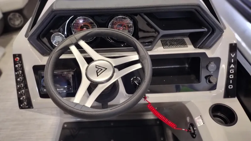 Slide: The Image of 2024 Viaggio Lago X18U boat dashboard with steering wheel and control panel. - 14