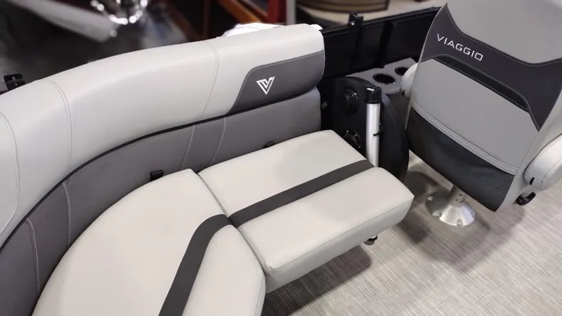 Slide: The Image of 2024 Viaggio Lago X18U boat interior with grey and black seating. - 16