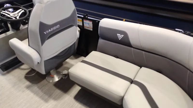 Slide: The Image of 2024 Viaggio Lago X18U boat interior with grey seating and steering console. - 17