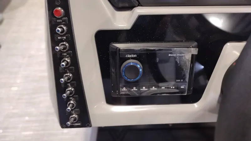 Slide: The Image of 2024 Viaggio Lago X18U control panel with Clarion audio system and various switches. - 18