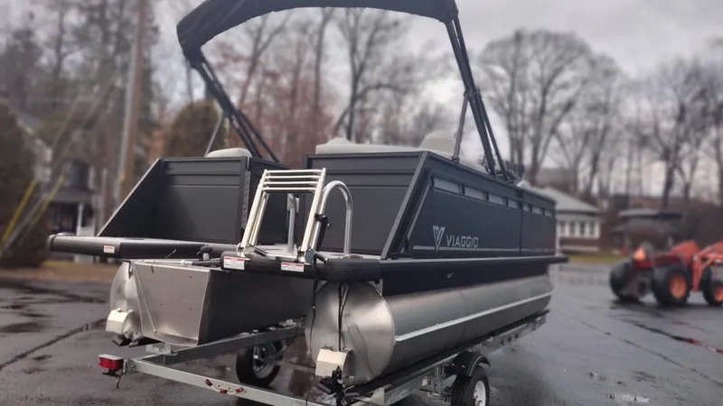 Slide: The Image of 2024 Viaggio Lago X18U pontoon boat on trailer, rear view. - 6