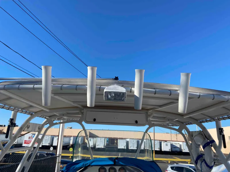 Slide: The Image of 2014 Wellcraft 35 Scarab Tournament boat with rod holders and canopy. - 12