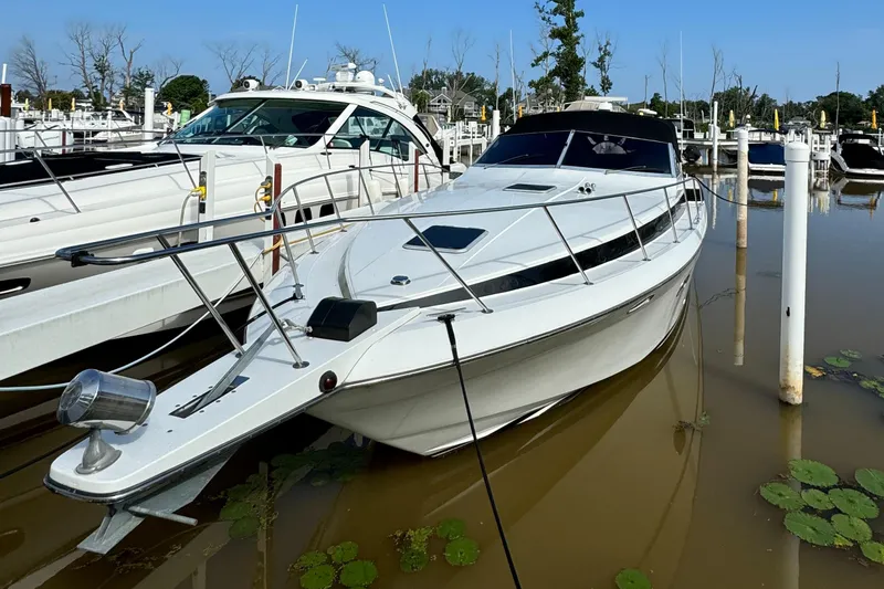 Slide: The Image of 1988 Chris-Craft Amerosport yacht docked in a marina. - 14