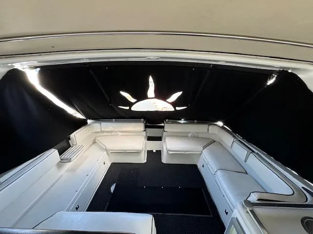 Slide: The Image of 1988 Chris-Craft Amerosport boat interior with white seating and black curtains. - 16