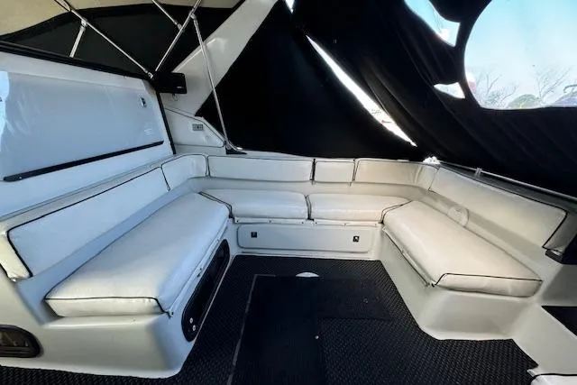Slide: The Image of 1988 Chris-Craft Amerosport boat interior with white cushioned seating and black accents. - 18
