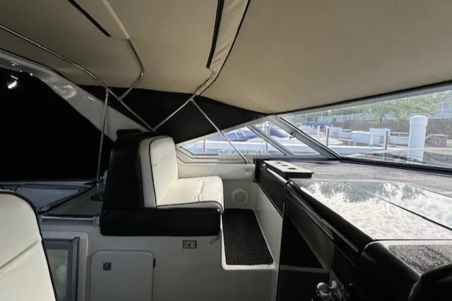 Slide: The Image of Interior of 1988 Chris-Craft Amerosport boat with white seating and large windows. - 21