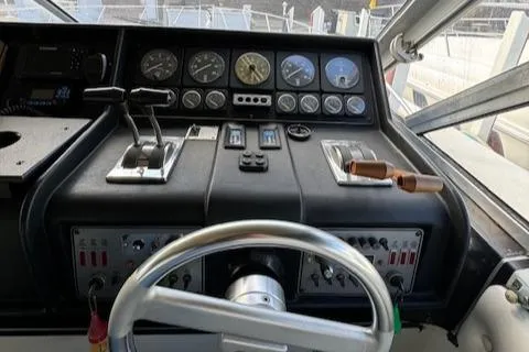Slide: The Image of 1988 Chris-Craft Amerosport boat dashboard with steering wheel and control panel. - 22