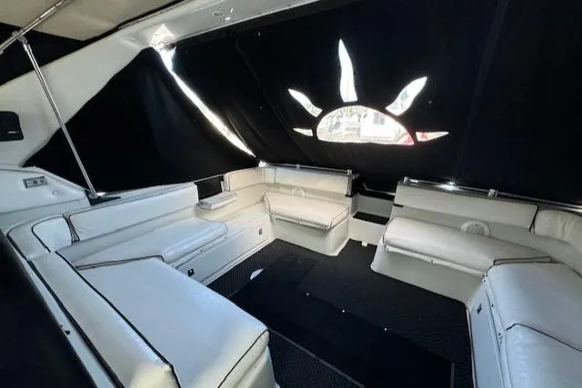 Slide: The Image of 1988 Chris-Craft Amerosport boat interior with white seating and black curtains. - 23