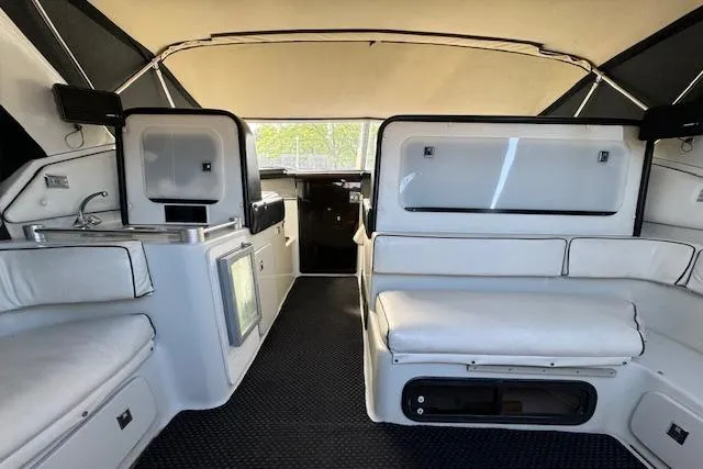 Slide: The Image of 1988 Chris-Craft Amerosport boat interior with white seating and kitchenette. - 25