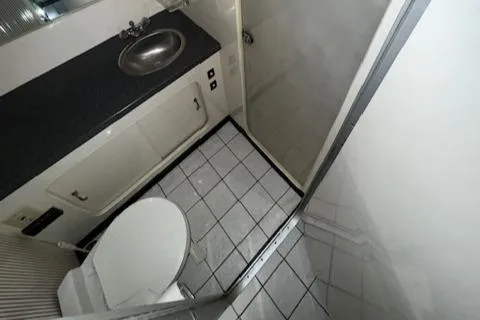 Slide: The Image of 1988 Chris-Craft Amerosport boat bathroom with toilet, sink, and shower. - 28