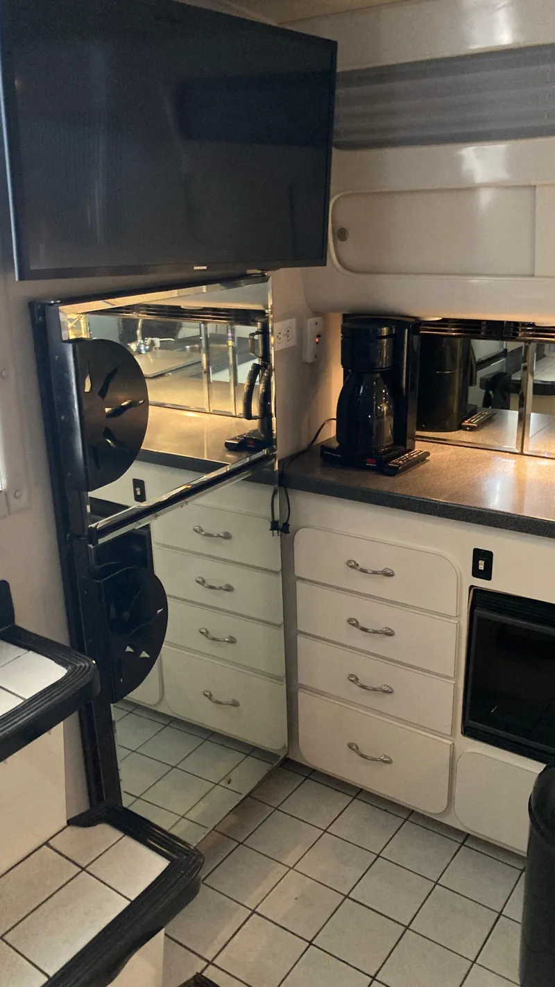 Slide: The Image of 1988 Chris-Craft Amerosport kitchen area with modern appliances and tiled flooring. - 31