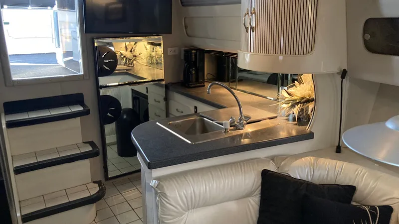 Slide: The Image of Interior of 1988 Chris-Craft Amerosport yacht with modern kitchen and cozy seating area. - 32