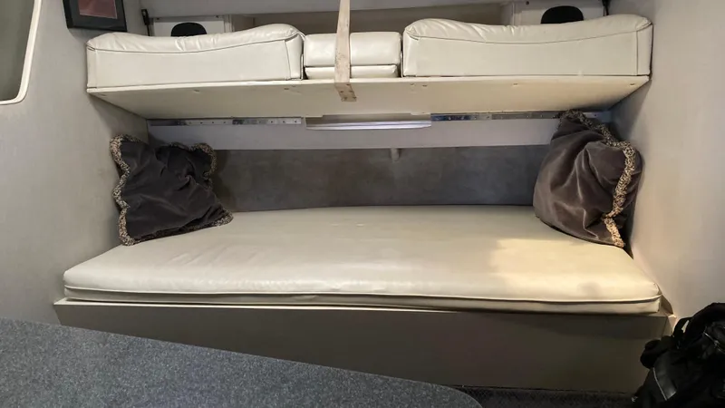 Slide: The Image of 1988 Chris-Craft Amerosport cabin interior with bunk beds and cushions. - 34