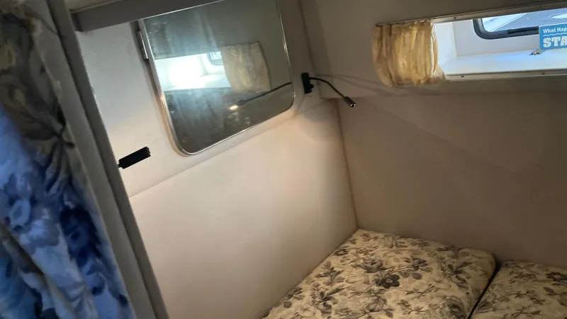 Slide: The Image of Interior cabin of 1988 Chris-Craft Amerosport boat with floral cushions and windows. - 35