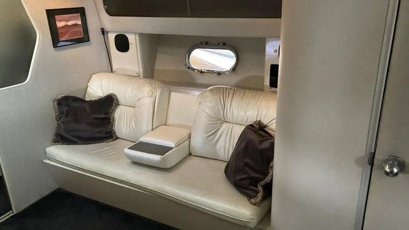 Slide: The Image of Interior of 1988 Chris-Craft Amerosport boat with white leather seating and decorative pillows. - 38