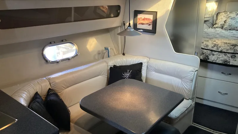 Slide: The Image of 1988 Chris-Craft Amerosport cabin interior with dining area and cozy seating. - 39