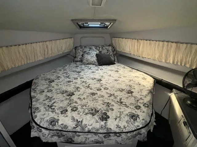 Slide: The Image of 1988 Chris-Craft Amerosport cabin interior with floral bedspread and side windows. - 42