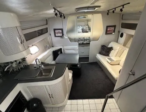 Slide: The Image of Interior of 1988 Chris-Craft Amerosport boat with kitchen, seating area, and sleeping quarters. - 43
