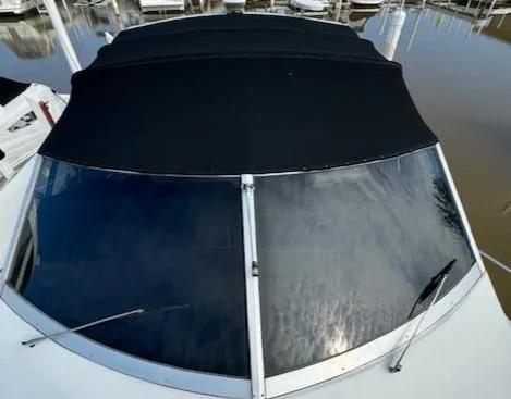 Slide: The Image of 1988 Chris-Craft Amerosport boat with black canvas cover and windshield. - 44