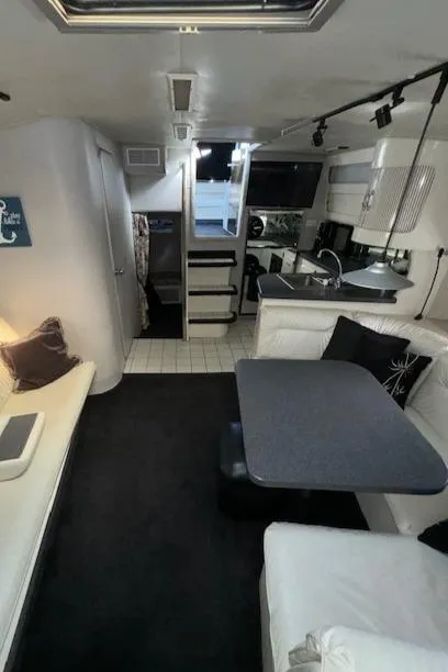 Slide: The Image of Interior of a 1988 Chris-Craft Amerosport boat with seating and kitchenette. - 45