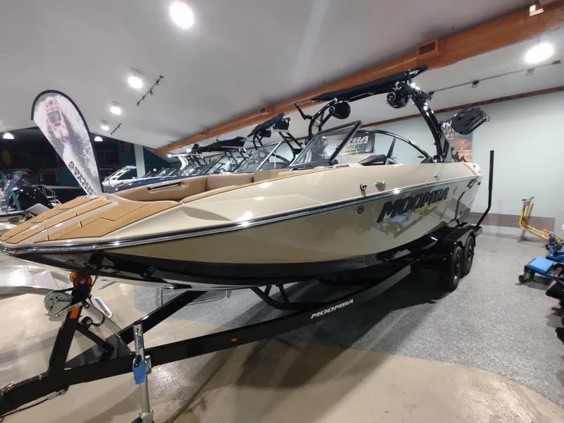 Slide: The Image of 2024 Moomba Makai boat on display in a showroom. - 11